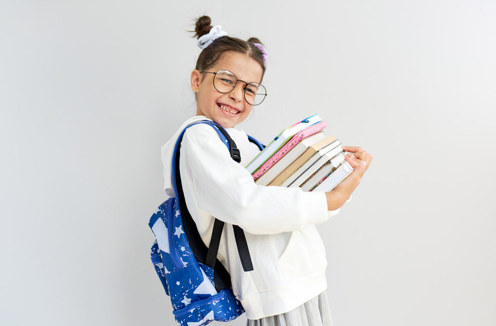 girl carrying a stack of books